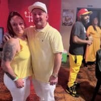 Vibrant group celebrating at Do it a-Ginn Event Hall, featuring lively social gathering, colorful attire, and cheerful interactions, perfect for hosting memorable parties and events.