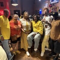 - Vibrant group enjoying social event at Do it a-Ginn Event Hall, showcasing warm atmosphere and diverse attendees.