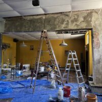 Ceiling renovation in progress at Do it a-Ginn Event Hall, featuring construction tools, ladders, and renovation materials, creating an inviting space for events and celebrations.