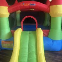 Bright, colorful inflatable bounce house with slide at Do it a-Ginn Event Hall, perfect for children's parties, family events, and fun-filled gatherings. Featuring vibrant colors and safe design for kids' entertainment.